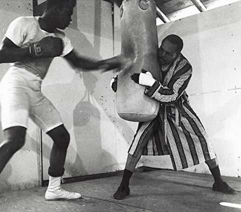 Muhammad Ali training with a boxing bag Photo Print (10 x 8)